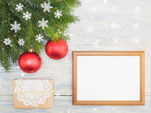 istock Fir tree branch with red toys, present, frame, snowflake on white wooden background. Christmas and New Year concept 1176570865