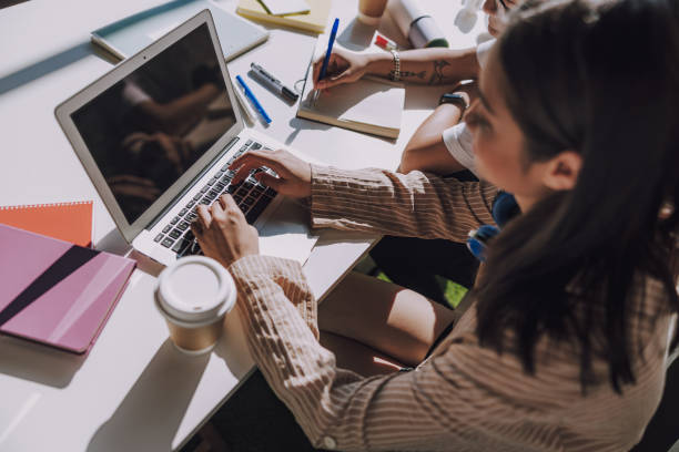 istock Female Asian student studying at table indoors 1176571084