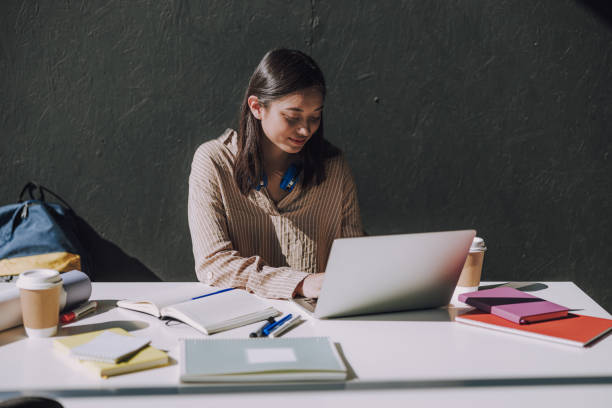istock Amazing female Asian student making project on laptop 1176571105