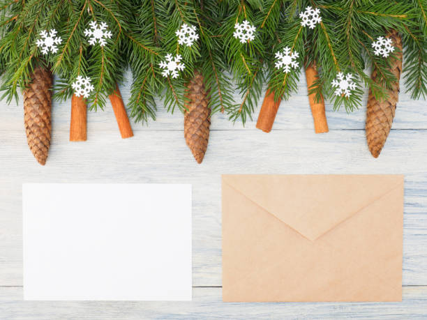 istock Fir tree branch with cinnamon, cones, snowflakes, envelope on wooden background. Winter holidays concept 1176571659
