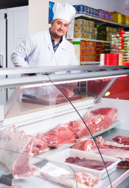 istock Smiling man near display with cooled meat 1176572592