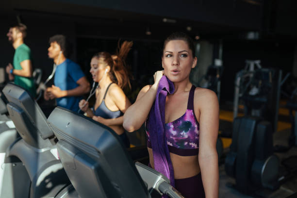 istock Young woman exhausted from working out on treadmill 1176573132