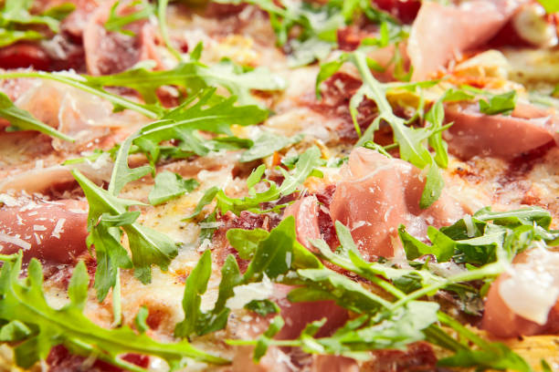 istock Tasty parma ham and artichoke pizza closeup 1176573440