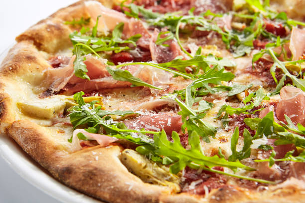 istock Tasty parma ham and artichoke pizza closeup 1176573444