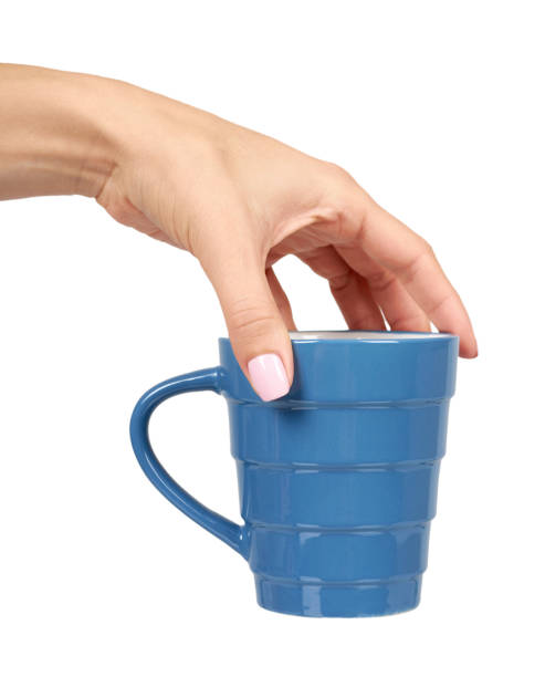 istock Hand with blue ceramic cup, mug for coffee and tea, kitchen pottery. 1176575284