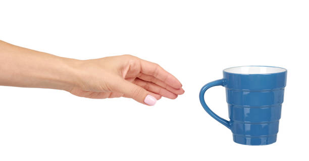 istock Hand with blue ceramic cup, mug for coffee and tea, kitchen pottery. 1176575292