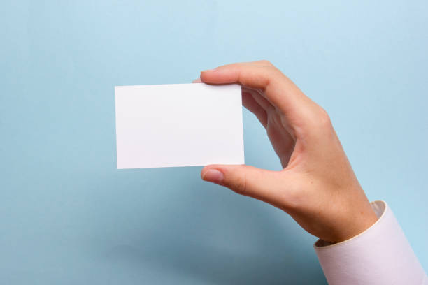 istock Hand holding white business card on white background 1176575385