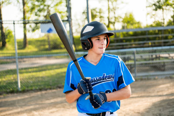 istock baseball players with bat on the playground 1176575430