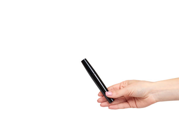istock Hand with black mascara, eye makeup brush. 1176575966