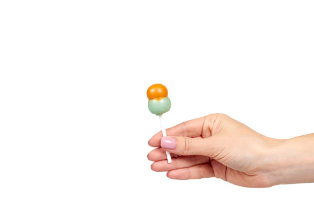 istock Hand with color lollipop, bright cool candy. 1176576671