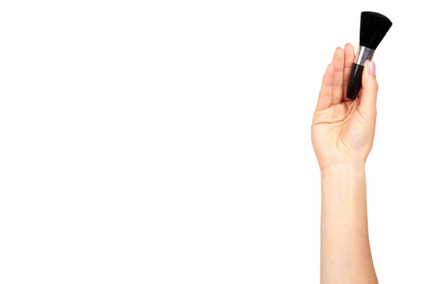 istock Hand with black eye makeup brush. Isolated 1176576886