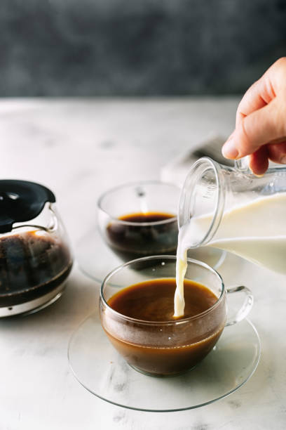 istock Pouring a milk into morning cup of coffee 1176577270