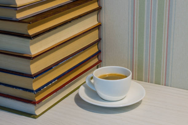 istock A stack of books and a Cup of espresso on a white table 1176577501