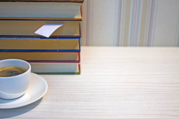 istock A stack of books and a Cup of espresso on a white table 1176577716