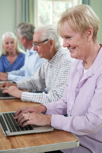 istock Senior Woman With Tutor In Computer Class 1176581779