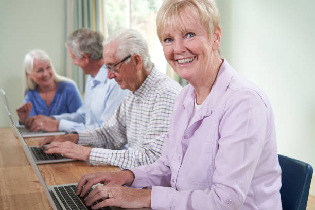 istock Portrait Of Senior Woman With Tutor In Computer Class 1176581850
