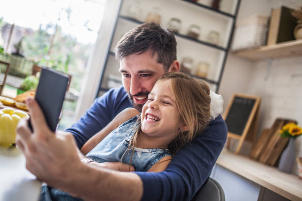 istock Father and daughter taking selfie in the kitchen 1176582247