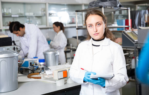 istock Female chemist writing results of experiments 1176584531