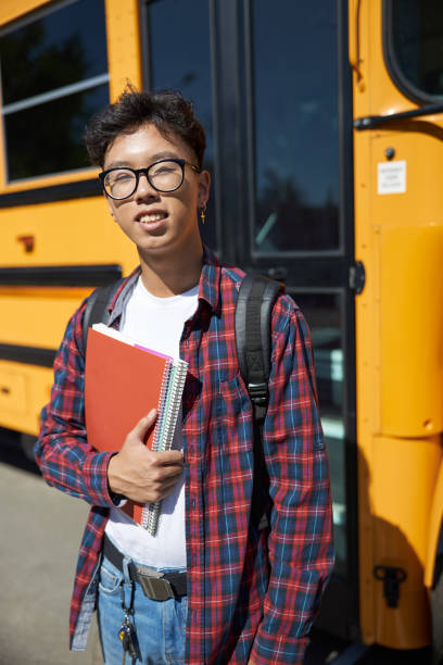istock Asian student is holding notebook outdoors 1176587734