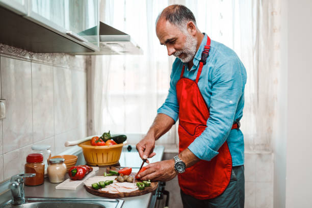 istock Mature man preparing healthy meal in the kitchen 1176588103