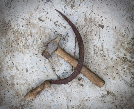 Sickle and hammer on concrete background, symbol, patriotism, cement background