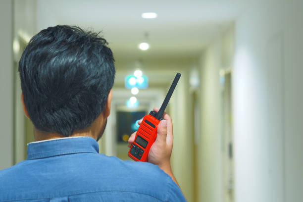 Man with a Walkie Talkie or Portable radio transceiver for Emergency Response Plan Man with a Walkie Talkie or Portable radio transceiver for Emergency Response Plan transceiver stock pictures, royalty-free photos & images