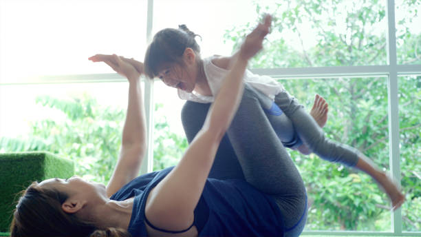istock Asian Mother Practicing Yoga With Her Daughter 1176591520