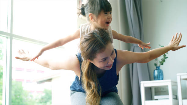 istock Asian Mother Practicing Yoga With Her Daughter 1176592335