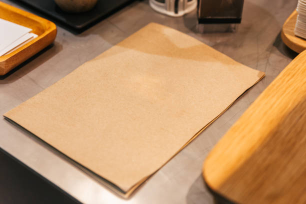 istock Empty brown paper cover menu place on coffee kitchen counter. 1176596265