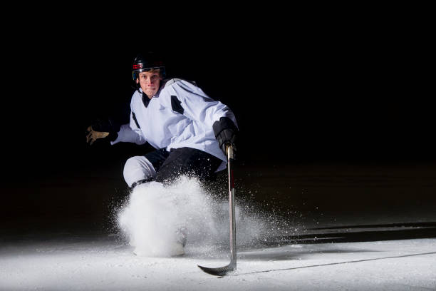istock Ice hockey player in action kicking with stick 1176596348