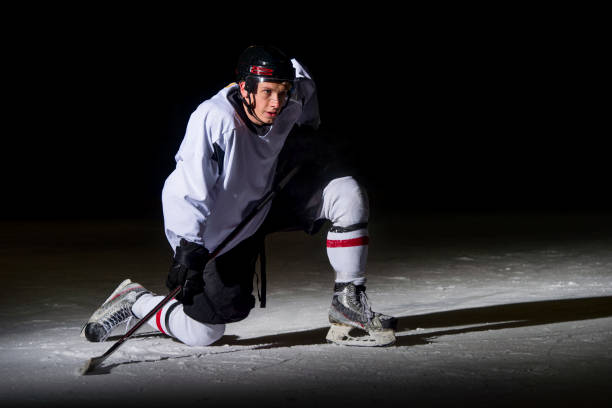 istock Ice hockey player in action kicking with stick 1176596351
