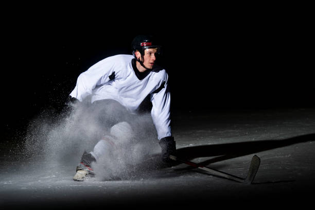 istock Ice hockey player in action kicking with stick 1176596377