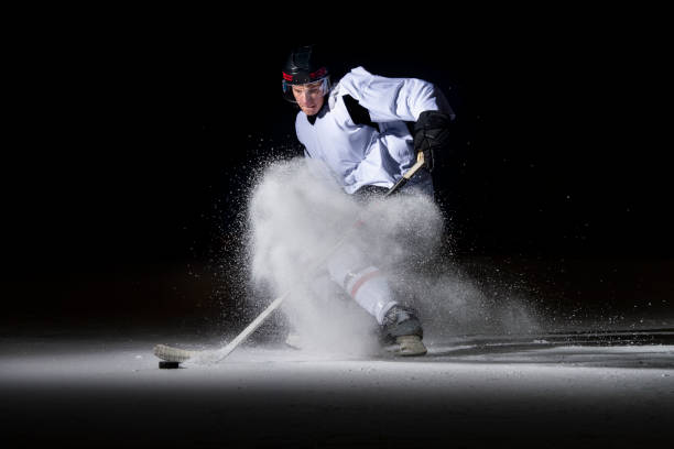 istock Ice hockey player in action kicking with stick 1176596378