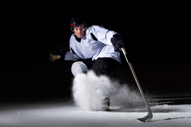 istock Ice hockey player in action kicking with stick 1176596405