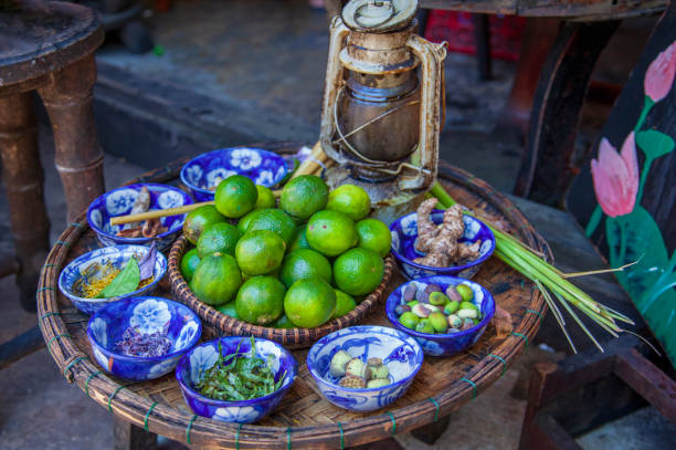 mot hoi n is a special herbal tea. its famous of herbal drink with lime and lotus petals. - lime market vietnam fruit imagens e fotografias de stock