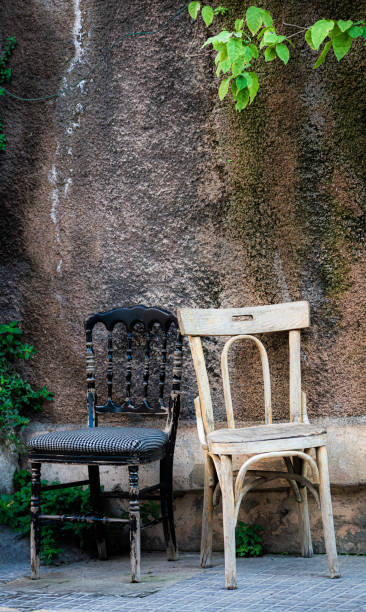 istock Two old chairs in front of a weathered wall 1176597400
