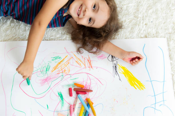 istock Little Girl Painting 1176599024