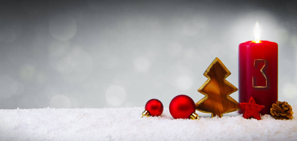 istock Third Advent.Christmas background with Advent candle and red decoration. 1176600171