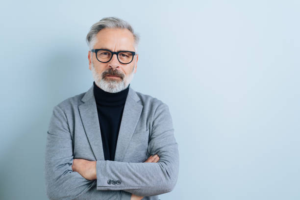 istock Serious man with folded arms staring at the camera 1176601891