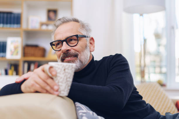 istock Middle-aged man relaxing in his living room 1176602089
