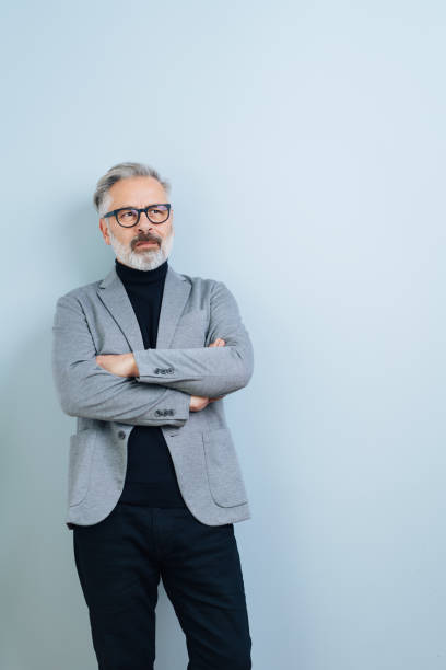 istock Middle-aged man with arms crossed, looking away 1176602198