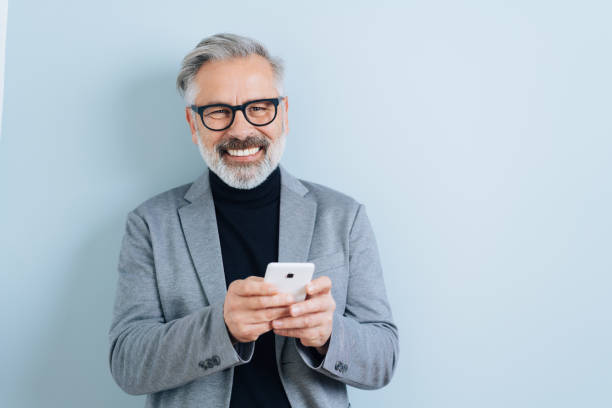 istock Laughing middle-aged man with smartphone 1176602336