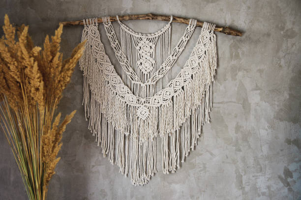 Macrame Wall Hanging Wall panel in the style of Boho made of cotton threads in natural color using the macrame technique for home decor and wedding decoration. Beautiful boho macrame wall panel will add a cozy atmosphere and charm to any space in your home macrame photos stock pictures, royalty-free photos & images