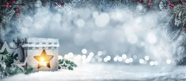 Photo of Christmas background with lantern, fir branches and bokeh lights