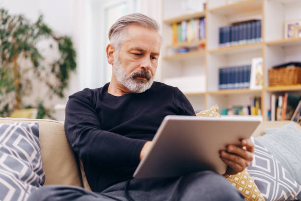 istock Senior man working on a tablet at home 1176603464