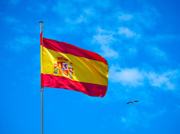 istock National Spanish flag in blue sky with clouds Spain 1176603754