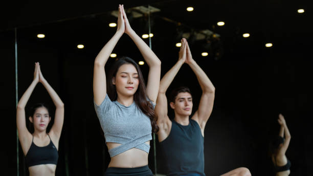 istock Multi-national people group Practicing yoga skills In the gym is an activity that makes the body healthy. Have a relaxed mind And helps the muscles to be flexible Not being an office syndrome. 1176605071