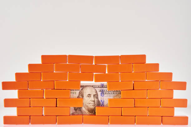 istock Broken brick wall with a dollar bill in hole. Business and finance concepte 1176605201