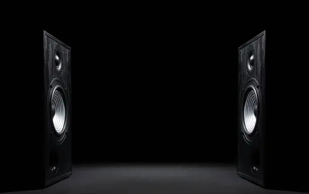 Two sound speakers with free space between them on black  background.