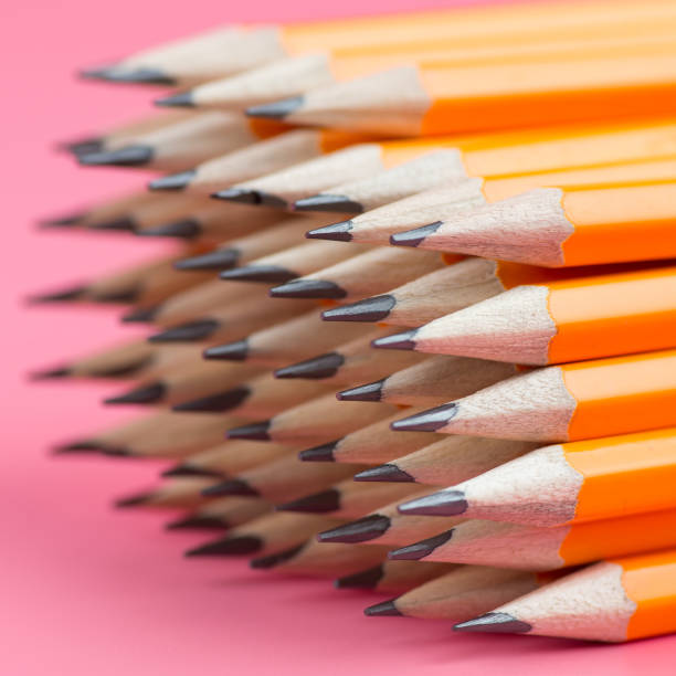 istock Stack of orange pencils on a pink background with place for your text. Back to school concept. 1176606748